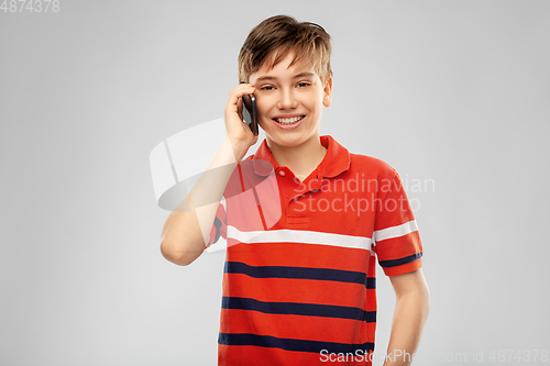 Image of happy smiling boy calling on smartphone