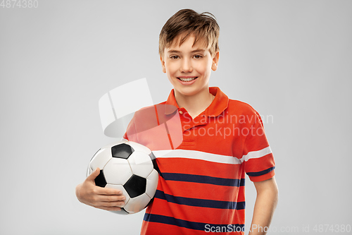 Image of happy smiling boy holding soccer ball