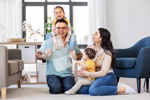 Image of portrait of happy family sitting on sofa at home