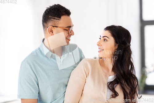 Image of happy couple looking at each other at home