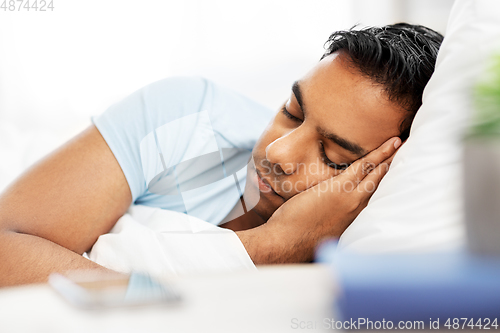 Image of indian man sleeping in bed at home