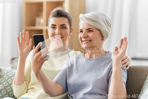 Image of daughter and old mother having video call on phone