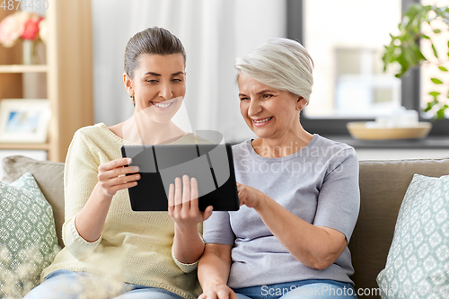 Image of daughter and senior mother with tablet pc at home