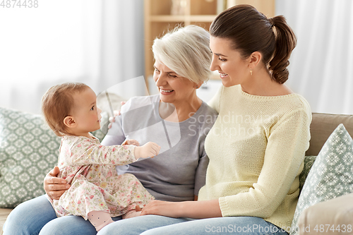 Image of mother, daughter and grandmother on sofa at home