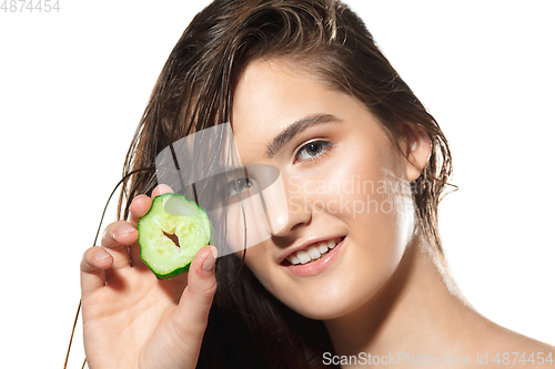 Image of Close up of beautiful female face with organic treatment over white background. Cosmetics and makeup, natural and eco treatment, skin care.