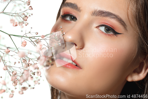 Image of Close up of beautiful female face with organic treatment over white background. Cosmetics and makeup, natural and eco treatment, skin care.