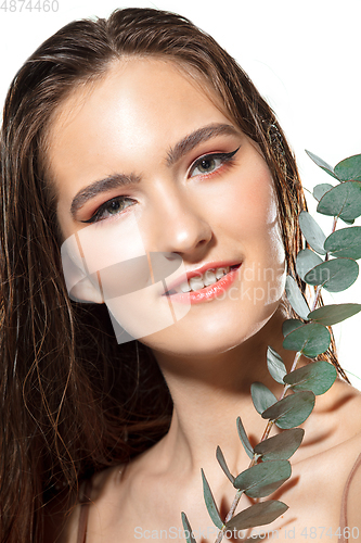 Image of Close up of beautiful female face with organic treatment over white background. Cosmetics and makeup, natural and eco treatment, skin care.