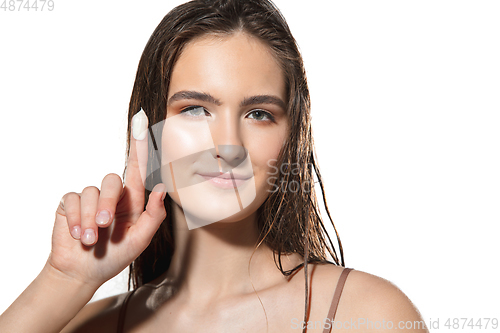 Image of Close up of beautiful female face with organic treatment over white background. Cosmetics and makeup, natural and eco treatment, skin care.