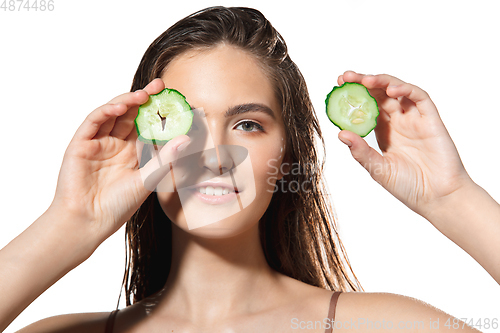 Image of Close up of beautiful female face with organic treatment over white background. Cosmetics and makeup, natural and eco treatment, skin care.