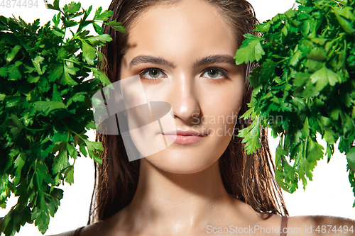 Image of Close up of beautiful female face with organic treatment over white background. Cosmetics and makeup, natural and eco treatment, skin care.