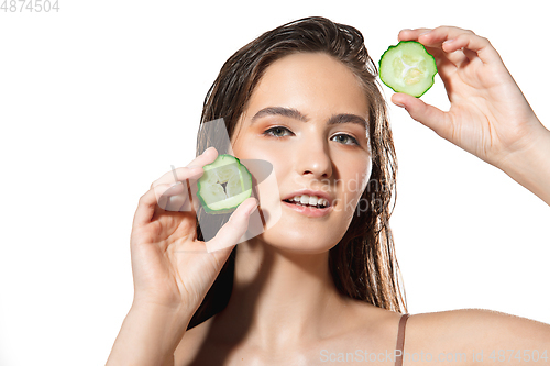 Image of Close up of beautiful female face with organic treatment over white background. Cosmetics and makeup, natural and eco treatment, skin care.