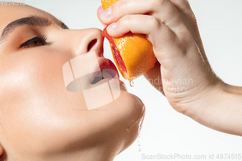 Image of Close up of beautiful female face with organic treatment over white background. Cosmetics and makeup, natural and eco treatment, skin care.