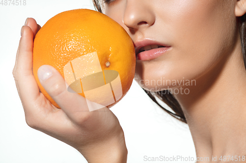 Image of Close up of beautiful female face with organic treatment over white background. Cosmetics and makeup, natural and eco treatment, skin care.