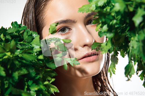Image of Close up of beautiful female face with organic treatment over white background. Cosmetics and makeup, natural and eco treatment, skin care.