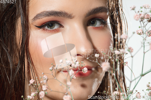 Image of Close up of beautiful female face with organic treatment over white background. Cosmetics and makeup, natural and eco treatment, skin care.
