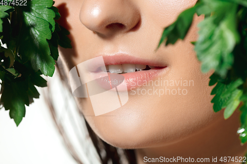 Image of Close up of beautiful female face with organic treatment over white background. Cosmetics and makeup, natural and eco treatment, skin care.