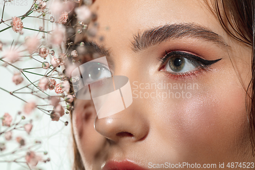 Image of Close up of beautiful female face with organic treatment over white background. Cosmetics and makeup, natural and eco treatment, skin care.