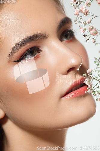 Image of Close up of beautiful female face with organic treatment over white background. Cosmetics and makeup, natural and eco treatment, skin care.