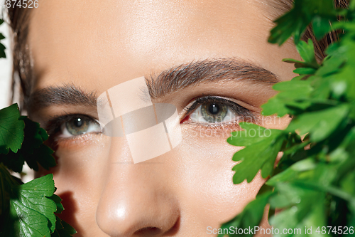 Image of Close up of beautiful female face with organic treatment over white background. Cosmetics and makeup, natural and eco treatment, skin care.