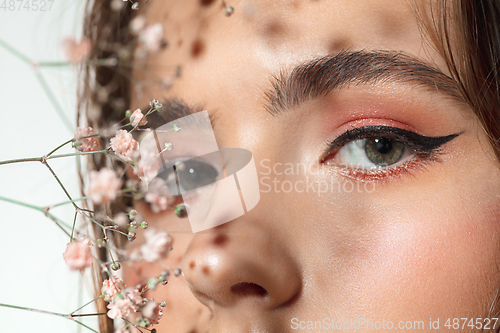 Image of Close up of beautiful female face with organic treatment over white background. Cosmetics and makeup, natural and eco treatment, skin care.