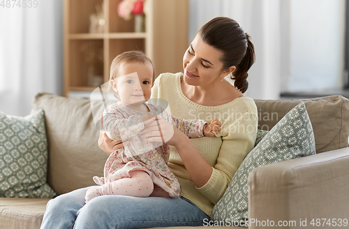 Image of happy mother with little baby daughter at home