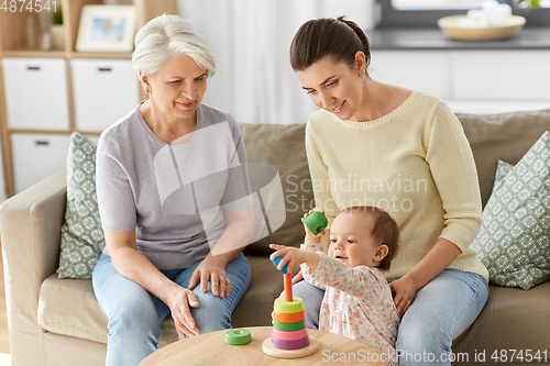 Image of mother, baby daughter and granny playing at home