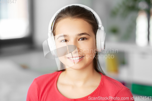 Image of girl in headphones listening to music at home