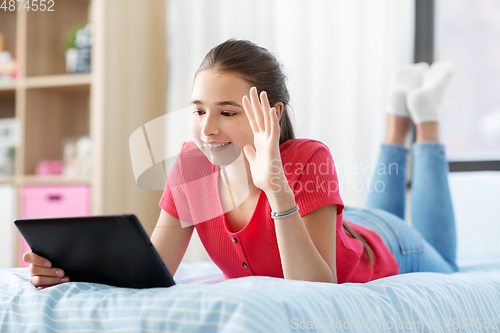 Image of girl having vide call on tablet computer at home