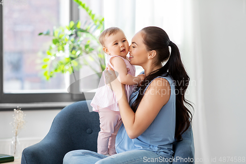 Image of happy mother with little baby daughter at home