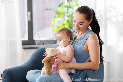 Image of happy mother with little baby daughter at home