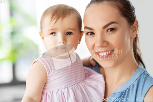 Image of happy mother with little baby daughter at home