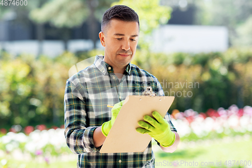 Image of man with clipboard at summer garden