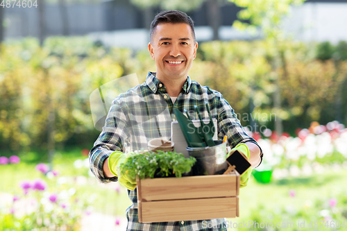 Image of happy man with tools in box at summer garden