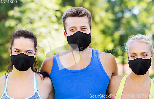 Image of group of happy friends or sportsmen at summer park