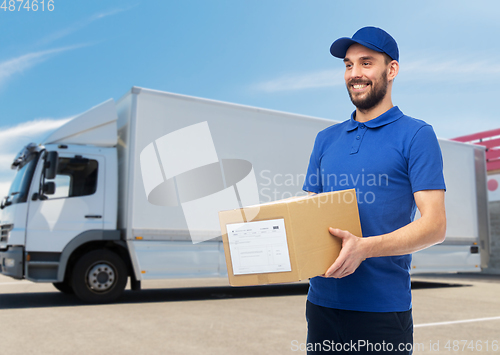 Image of happy delivery man with parcel box