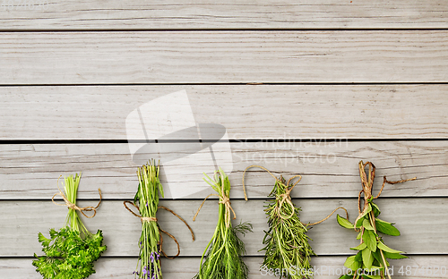 Image of greens, spices or medicinal herbs on wooden boards