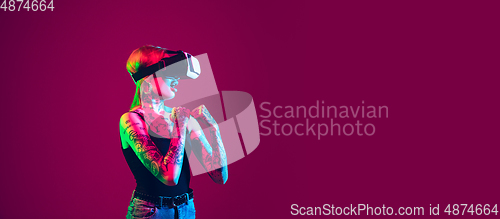 Image of Portrait of young caucasian woman on purple background with copyspace, unusual and freaky appearance