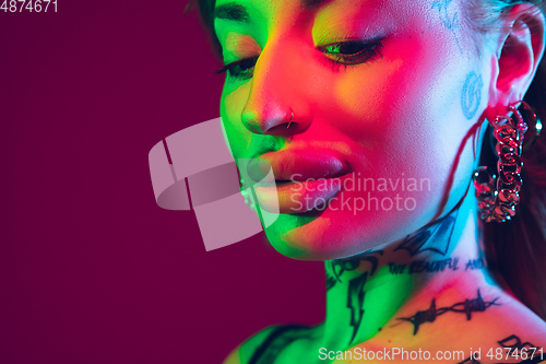 Image of Portrait of young caucasian woman on purple background with copyspace, unusual and freaky appearance