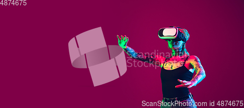 Image of Portrait of young caucasian woman on purple background with copyspace, unusual and freaky appearance