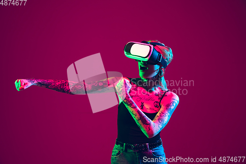 Image of Portrait of young caucasian woman on purple background with copyspace, unusual and freaky appearance