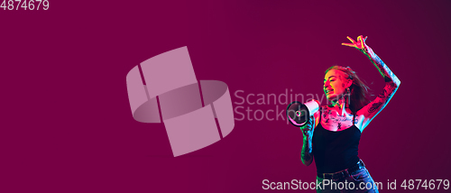 Image of Portrait of young caucasian woman on purple background with copyspace, unusual and freaky appearance