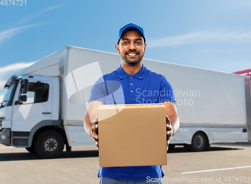 Image of happy indian delivery man with parcel box in blue