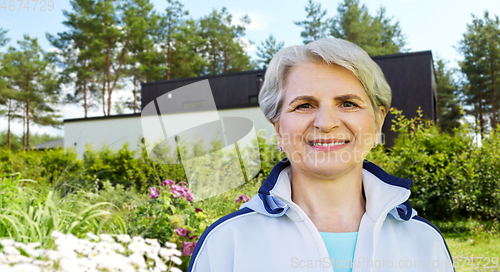 Image of smiling sporty senior woman at summer park