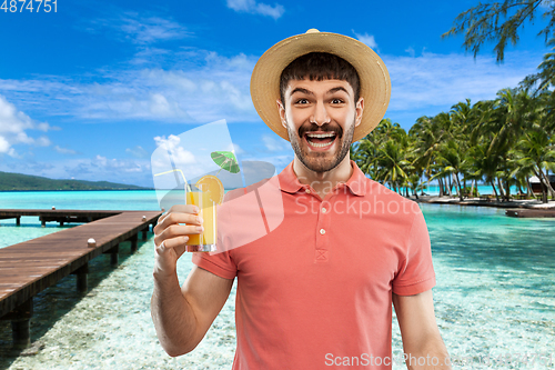 Image of happy man in straw hat with orange juice cocktail