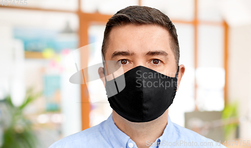 Image of middle-aged man in reusable face protective mask