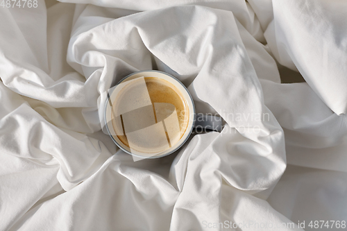 Image of cup of coffee in bed