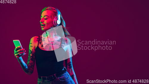 Image of Portrait of young caucasian woman on purple background with copyspace, unusual and freaky appearance