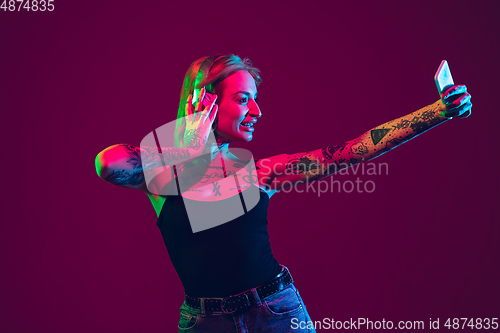 Image of Portrait of young caucasian woman on purple background with copyspace, unusual and freaky appearance