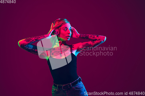 Image of Portrait of young caucasian woman on purple background with copyspace, unusual and freaky appearance