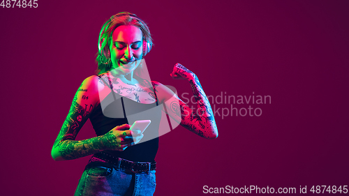 Image of Portrait of young caucasian woman on purple background with copyspace, unusual and freaky appearance